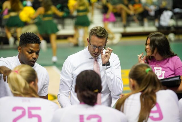 Head coach Ryan McGuyre strategizes with his team at the Baylor vs Cincinnati University Volleyball Game on Friday evening at the Ferrell Center. Caleb Garcia | Photographer