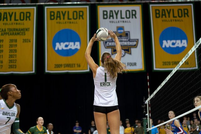 Redshirt sophomore setter Harley Kreck provides a perfect set for her teammates at the net in the Bears' 3-2 loss against Kansas Friday night at the Ferral Center. Brady Harris | Photographer