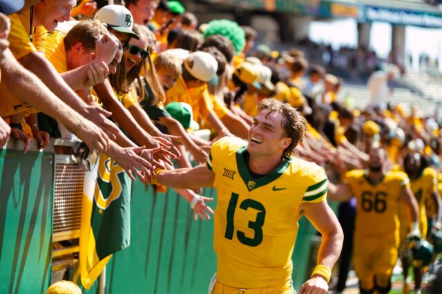 Redshirt senior quarterback Sawyer Robertson celebrates with the Baylor Line after the big win. Brady Harris | Photographer