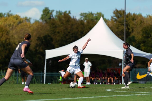 Junior forward Callie Conrad splits two defenders to take a shot on goal. Brady Harris | Photographer