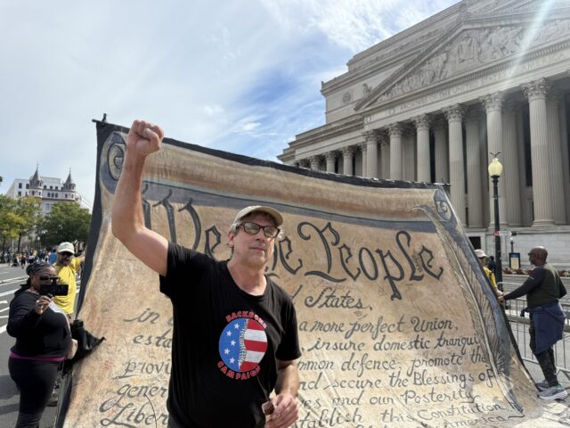 Bill Moyer, the executive director of Backbone Campaign, stands with the Constitution banner he coordinated for the No Kings protests in Washington, D.C. Saturday morning. Christina Ikhbeis | Social Media Assistant