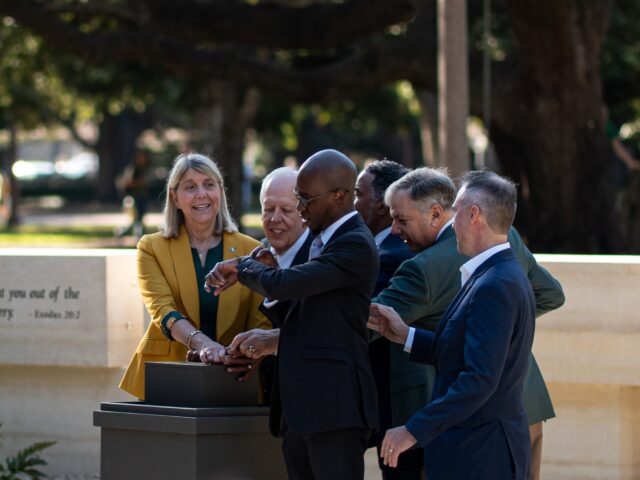 The speakers for the dedication ceremony to the Memorial of Enslaved Persons gather to turn on the fountain on Friday morning at Founders Mall. Alyssa Meyers | Photographer.