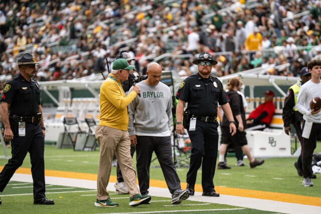 Head coach Dave Aranda gets interviewed on the sideline during the Bears' 31-24 loss against the Houston Cougars. Alyssa Meyers | Photographer
