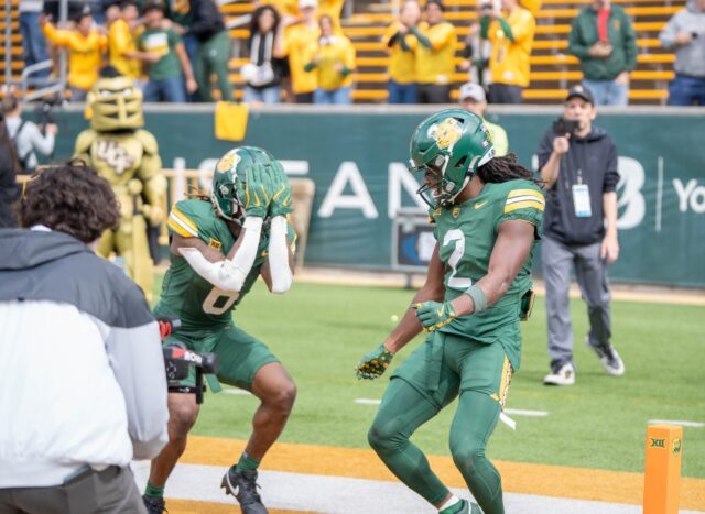 Sixth-year wide receiver Ashtyn Hawkins and senior wide receiver Kole Wilson dance in the end zone to celebrate Wilson's touchdown. Sam Gassaway | Photographer