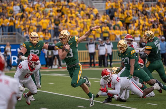 Redshirt senior quarterback Sawyer Robertson attempts to run the ball into the end zone during the Bears' 31-24 loss against Houston on Saturday. Sam Gassaway | Photographer