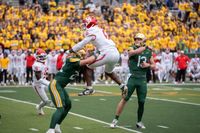 Houston's sophomore running back Jordan Allen attempts to intercept a pass from redshirt senior quarterback Sawyer Robertson during the Bears' 31-24 loss against Houston on Saturday. Sam Gassaway | Photographer