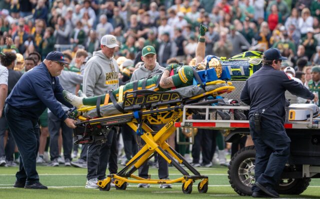 Freshman running back Caden Knighten raises his fist in the air after an injury during the Bears' 31-24 loss against Houston on Saturday. Sam Gassaway | Photographer
