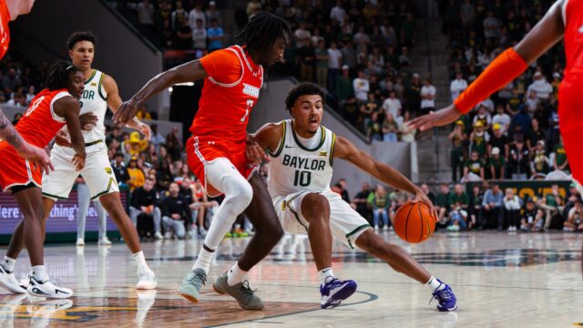 Sophomore guard Isaac Williams IV takes some contact while driving towards the basket. Brady Harris | Photographer