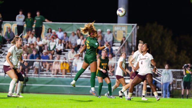 Junior midfielder Aryanna Jimison heads the ball towards the goal. Brady Harris | Photographer