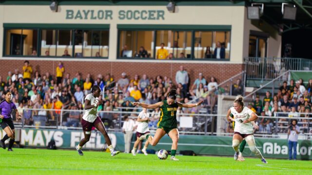 Senior midfielder Tyler Isgrig shoots in between two defenders. Brady Harris | Photographer