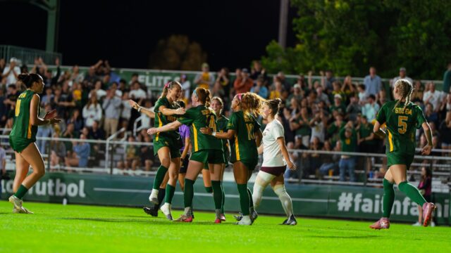 Freshman midfielder Olivia Hess celebrates with her team after scoring a goal. Brady Harris | Photographer