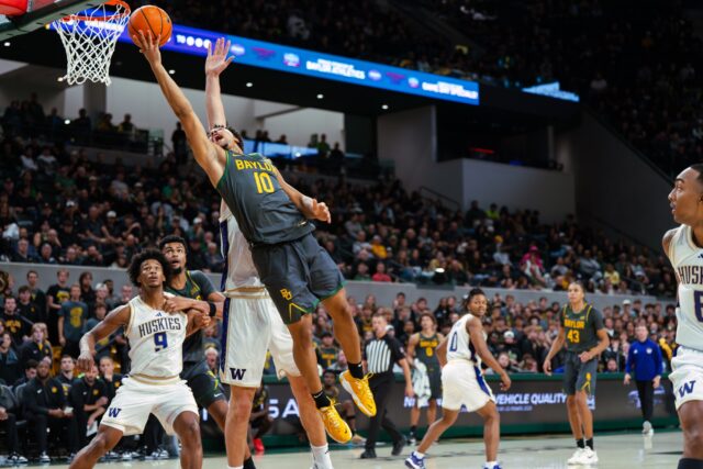 Sophomore guard Isaac Williams IV stretches out mid-air for a contested layup. Brady Harris | Photographer