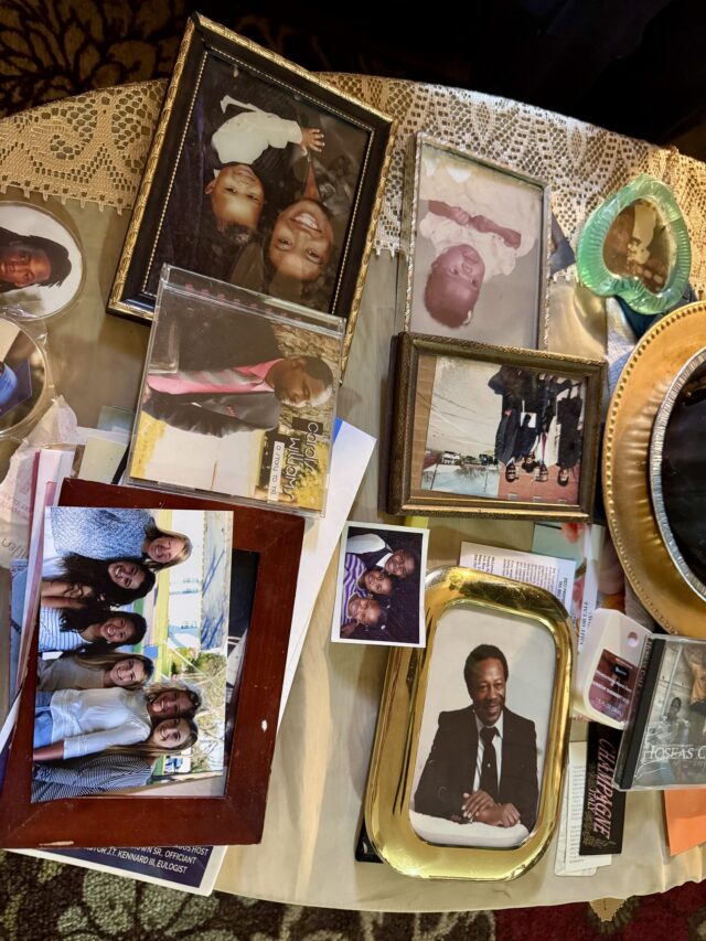 Family photos cover a coffee table inside the Bryant home on 11th Street. O'Connor Daniel | Reporter