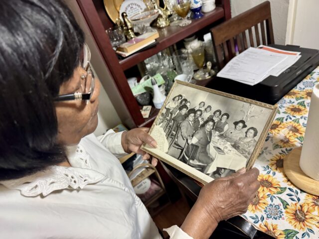 Bernice Bryant looks over an old family photo inside her dining room. O'Connor Daniel | Reporter
