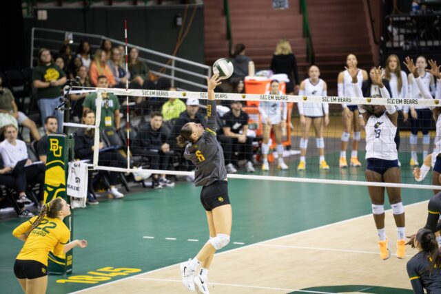 Freshman outside hitter Ksenia Rakhmanchik serves the ball during the Bears' 3-0 victory over West Virginia at the Ferrell Center on Friday. Sam Gassaway | Photographer