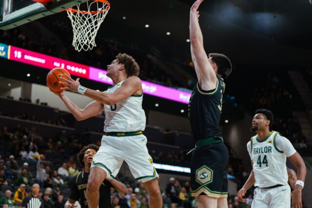 Senior guard Dan Skillings Jr. flies through the air underneath the basket to sink a layup. Brady Harris | Photographer