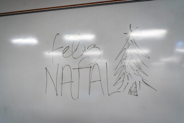 "Feliz Natal," Merry Christmas in Portuguese, was written on the board to greet students at the PSA holiday potluck on Friday. Sam Gassaway | Photographer