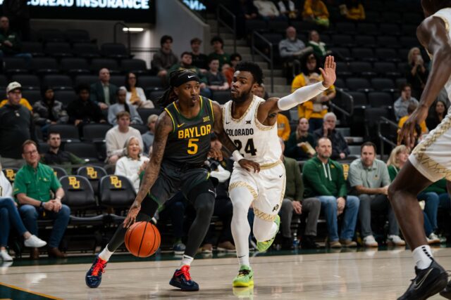Fifth-year guard Obi Agbim dribbles the ball through pressure during the Bears' Wednesday night 86-67 win at Foster Pavilion. Alyssa Meyers | Photographer
