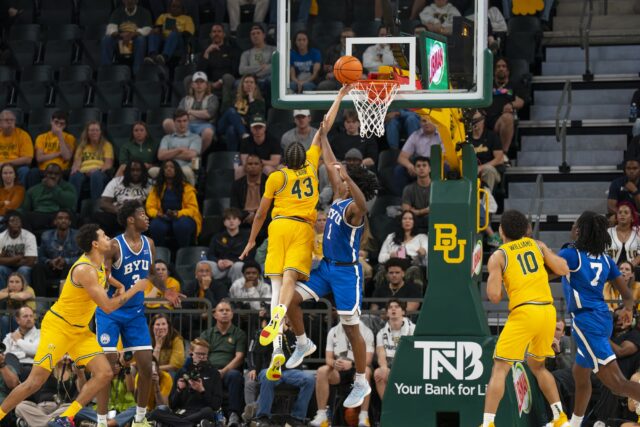 Redshirt sophomore Cameron Carr soars in for a score during the Bears' 99-94 loss to No. 22 BYU. Jake Schroeder | Photographer