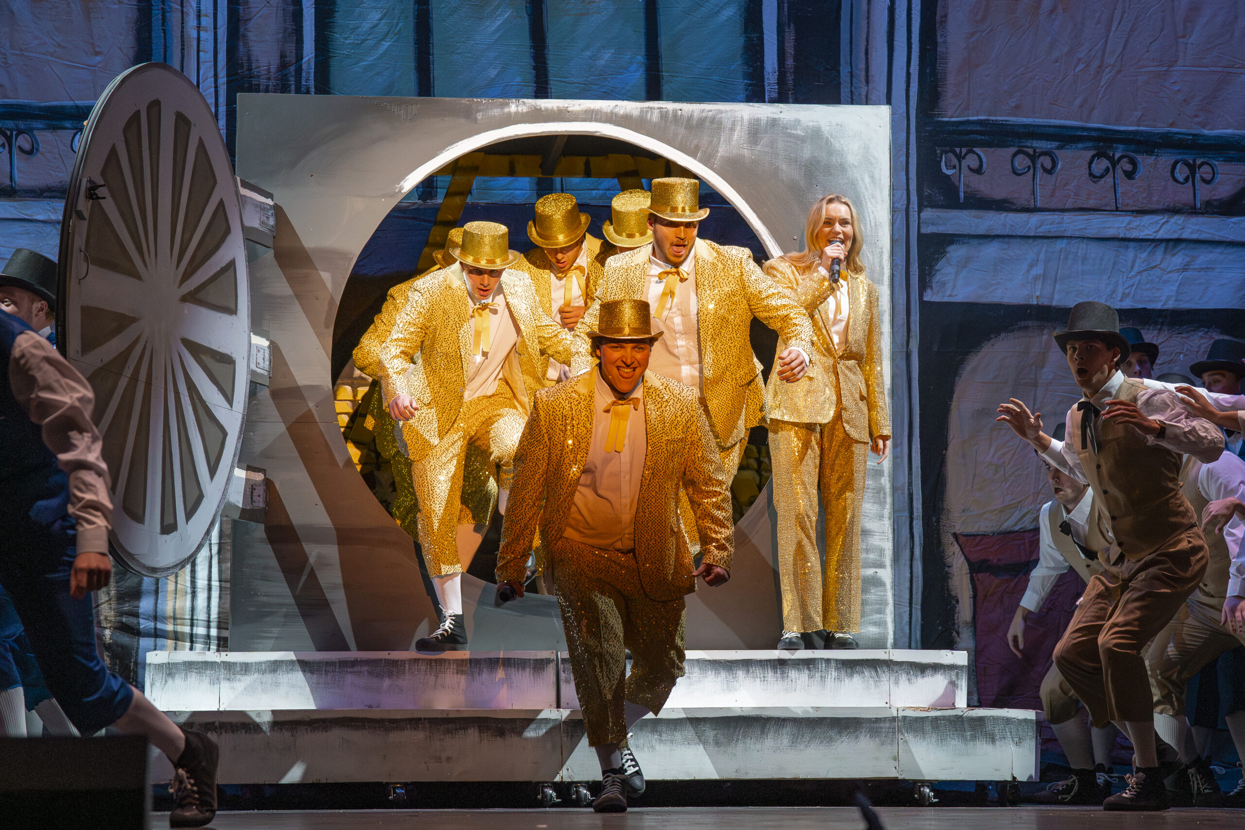 KOT brings a banker fantasy to life, decked out in sparkly gold suits and matching top hats. Jake Schroeder | Photographer