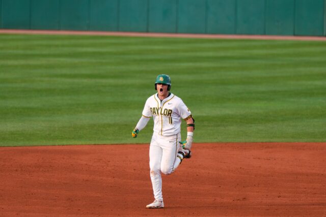 Redshirt senior first baseman Tyce Armstrong celebrates towards the dugout after hitting his first of three grand slams. Brady Harris | Photographer