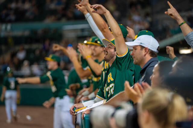 Players cheer after a successful swing against Texas State on Tuesday evening at Magnolia Field. Caleb Garcia | Photographer