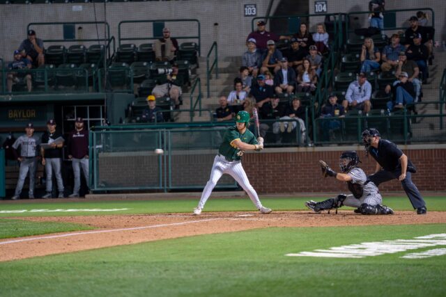 Redshirt sophomore first baseman John Youens winds up to swing at the Baylor vs Texas State Baseball game on Tuesday evening at Magnolia Field. Caleb Garcia | Photographer