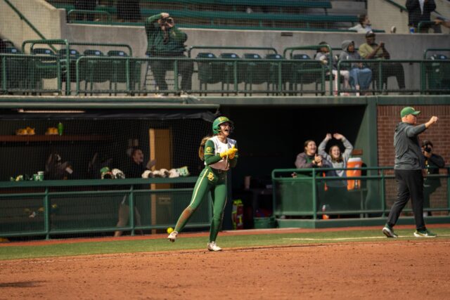 Sophomore outfielder Gigi Lindsey cheers for her teammate on the way to home plate during the Bears 10-2 victory over South Dakota State at Getterman Stadium on Tuesday. Sam Gassaway | Photo Editor