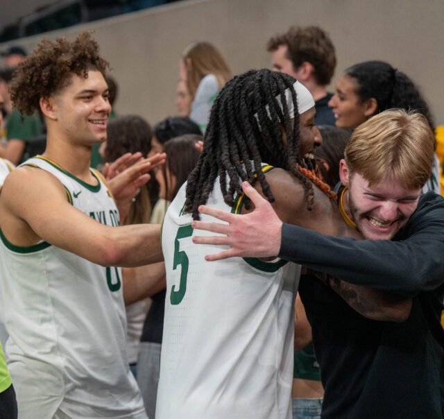 The Baylor bears celebrate with the crowd during No. 14 Baylor Men’s Basketball’s win 73-68 against Arizona State Saturday afternoon at Foster Pavilion. Mesha Mittanasala | Photographer