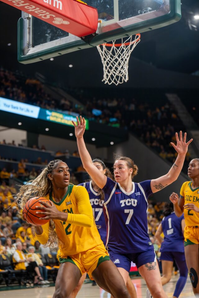 Redshirt junior Kyla Abraham passes the defense during No. 12 Baylor women's basketball's 67-83 loss over TCU Thursday night at Foster Pavilion. Mesha Mittanasala | Photographer