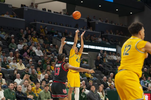 Redshirt Sophomore guard Cameron Carr throws up a three over Utah Freshman forward Kendyl Sanders. Jake Schroeder | Photographer