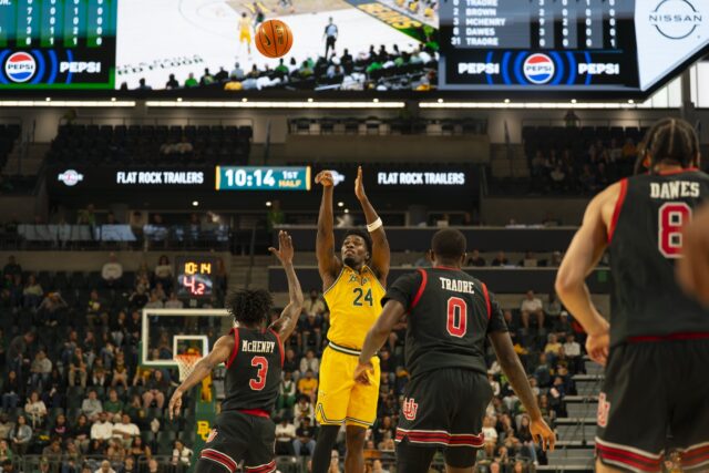 Freshman guard Tounde Yessoufou puts up a three-pointer over Utah Fifth-year guard Don McHenry. Jake Schroeder | Photographer
