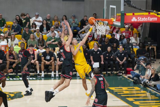 Senior guard Dan Skillings Jr. gets vertical to lay up a shot in front of Utah Junior forward Keanu Dawes. Jake Schroeder | Photographer