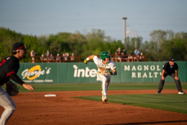 Freshman outfielder Brady Janusek races to third base during the Bears' .... victory over UIW at the Baylor Ballpark on Tuesday. Sam Gassaway | Photo Editor