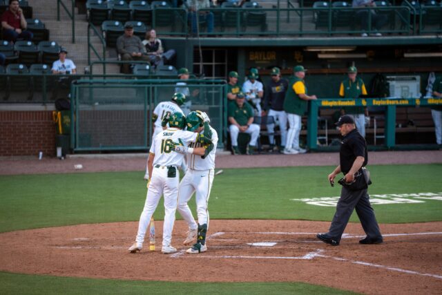 Redshirt senior first baseman Tyce Armstrong embraces his teammate, redshirt freshman Hunter Snow after hitting a home run during the Bears' .... victory over UIW at the Baylor Ballpark on Tuesday. Sam Gassaway | Photo Editor
