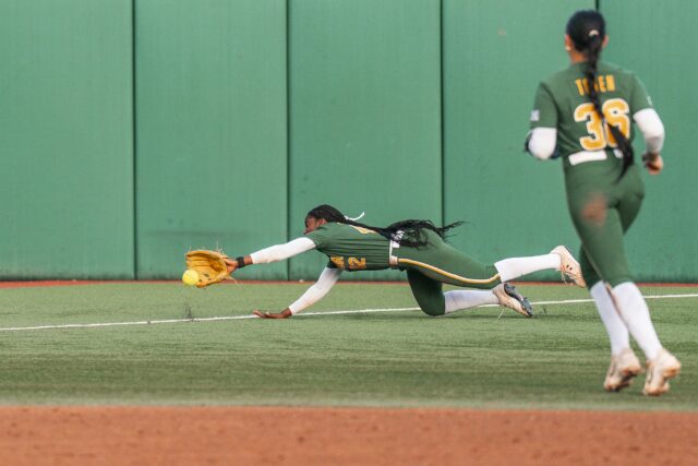Sophomore left fielder Karynton Dawson dives to stop a ball that lands just inside fair territory. Jake Schroeder | Photographer