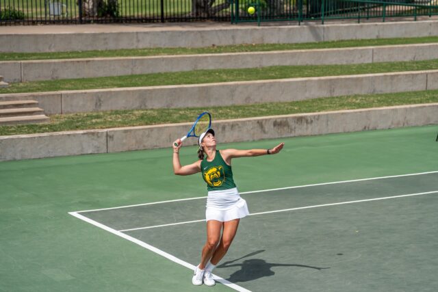 Freshman Luna Ivkovic prepares to serve on her way to a win. Brady Harris | Photographer