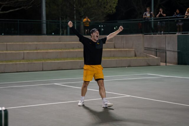 Junior Louis Bowden celebrates after winning the match-set point to upset Ohio State during the Bears' 4-2 win Thursday night at the Hurd Tennis Center. Alyssa Meyers | Photographer