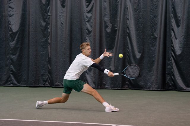 Graduate student Alexandru Chirita slices the ball during the Bears' match against TCU Sunday afternoon at Hawkins Indoor Tennis Center. Alyssa Meyers | Photographer