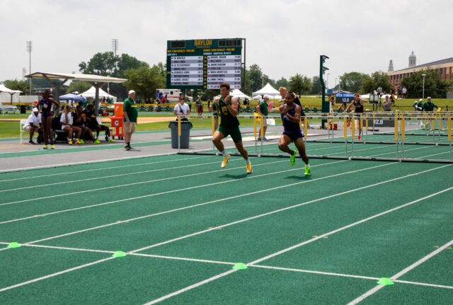 Werner Bezuidenhout pulls ahead in his hurdle race to win first in his heat.
