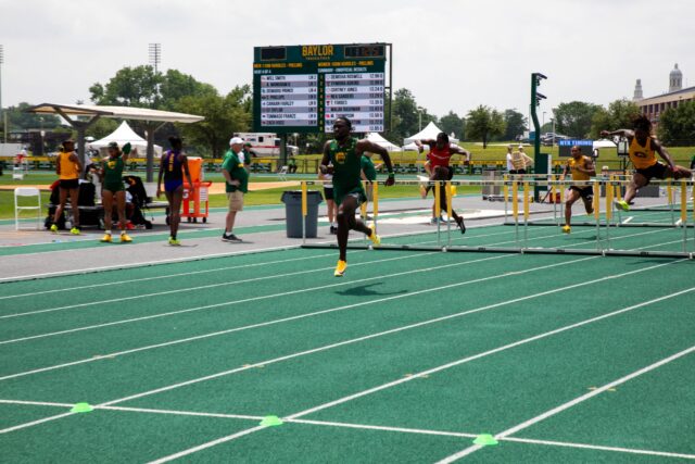 Demario Prince wins his heat in the hurdles.