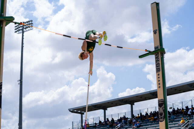 Freshman Pole Vaulter Grant Vlaun successfully makes it over the pole at the Baylor Invitational track meet at Clyde Hart Track and Field Stadium on Friday afternoon. Caleb Garcia | Photographer