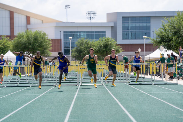 Freshman sprinter Werner Bezuidenhout takes the lead after hurdles at the Baylor Invitational meet at Clyde Hart Track and Field Stadium on Friday afternoon. Caleb Garcia | Photographer