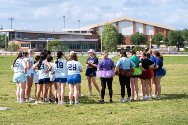 A coach informs both teams of the rules of the game at the Kicks for Casa event at the Baylor Softball fields on Saturday evening. Caleb Garcia | Photographer