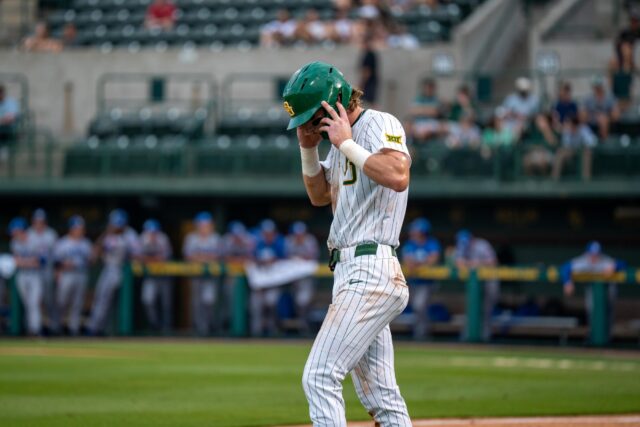 Redshirt junior infielder Travis Sanders returns to third base after a time out during the Bears' 6-2 victory over UTA on Tuesday. Sam Gassaway | Photo Editor