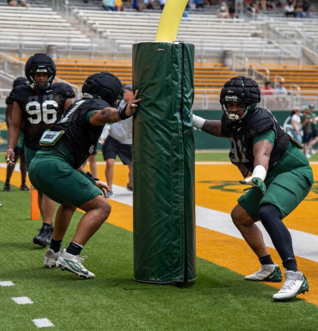 Defensive Linemen prepare for the next season by running drills and plays at  football open practice saturday afternoon at McLane Stadium. Alyssa Myers | Photographer