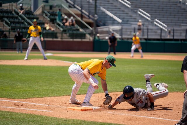 Redshirt senior first baseman Tyce Armstrong attempts to tag out Texas Tech left fielder Jace Souza out at first base during the Bears' 8-3 loss against the Red Raiders on Sunday. Sam Gassaway | Photo Editor