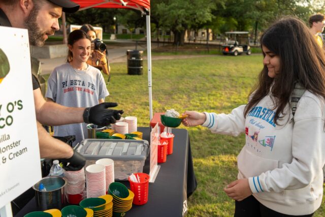 First year and transfer students recieve ice cream at the Cap It Off event on fountain mall monday evening. Mesha Mittanasala| Photographer