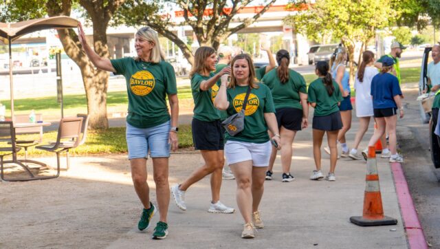 Dr. Linda Livingstone waves at students moving into Penland Hall during Move2BU on Thursday morning. Vanessa Adams | Photographer