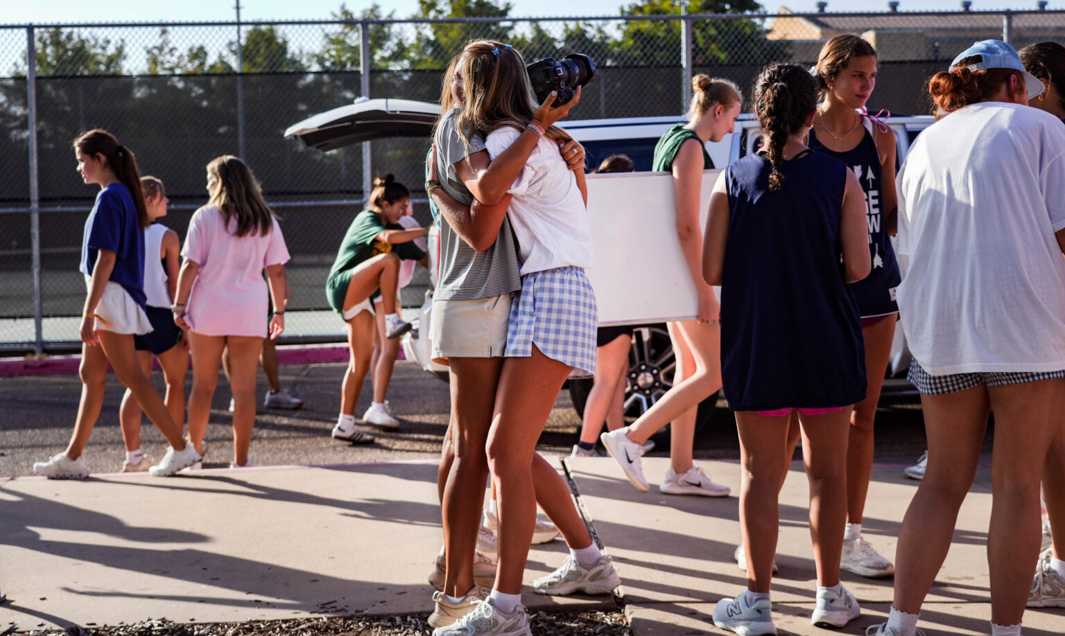 Outside of Penland Residence Hall, two volunteers embrace one another and prepare to welcome new students during Move2BU on Thursday morning. Mady Mijares | Photographer